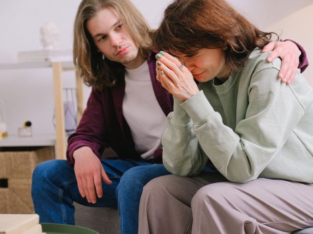 A man comforting his wife after receiving a DUI conviction.