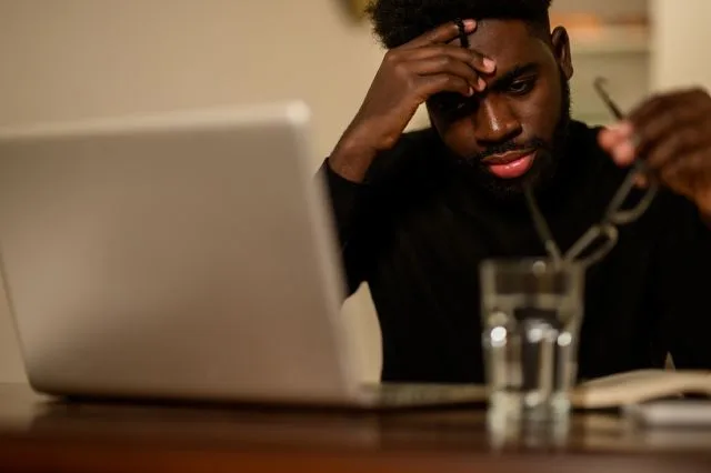 A man looking concerned while working through his online DUI treatment program.